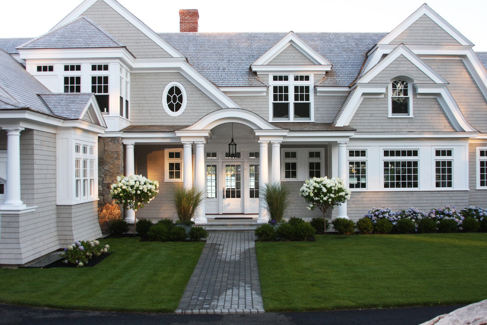 Design ideas for a large beach style front partial sun garden in Boston with concrete paving.