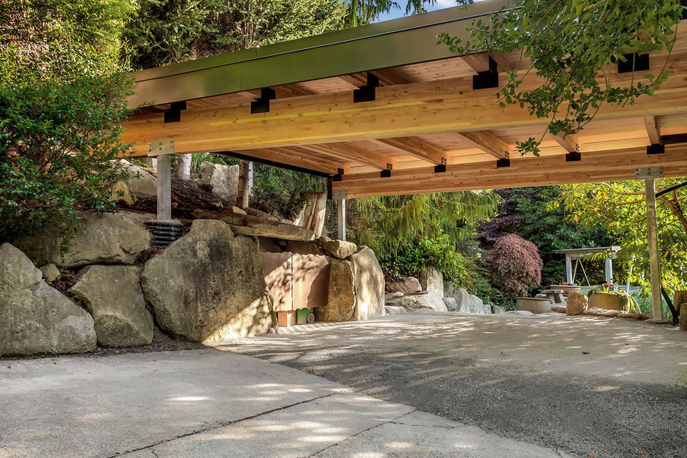Photo of a large modern front driveway partial sun garden in Seattle with a rockery and gravel.
