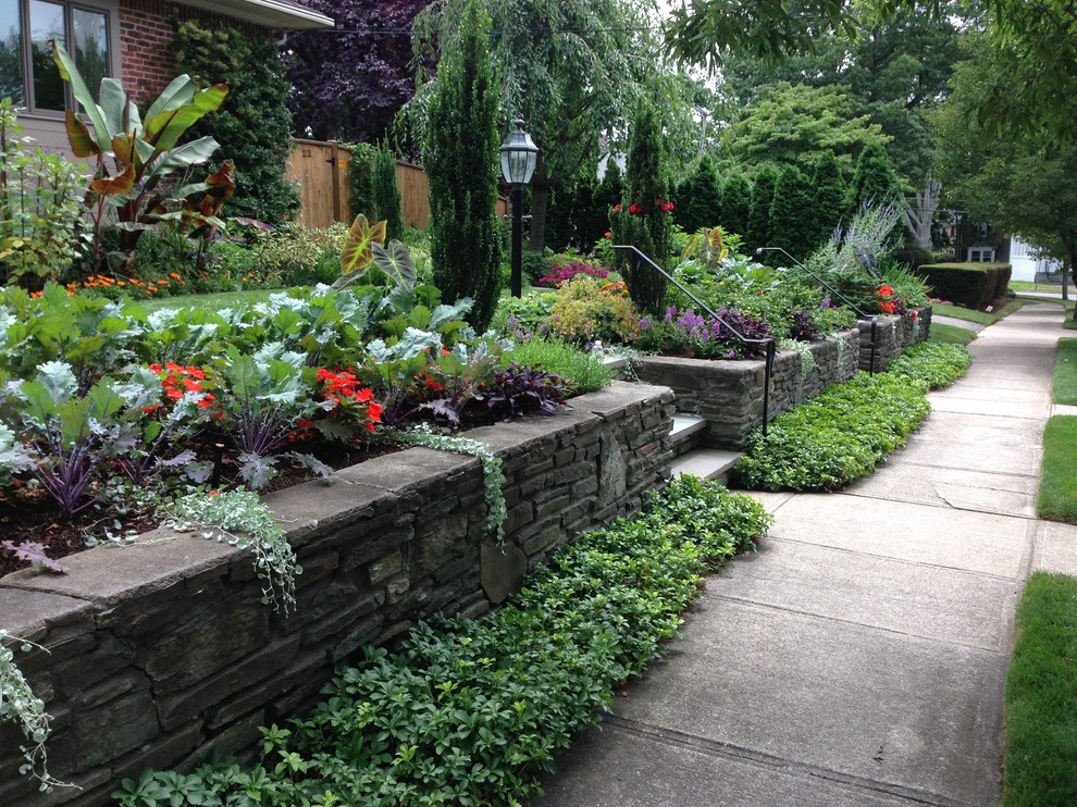 This is an example of a medium sized traditional front formal full sun garden for summer in Providence with a garden path and concrete paving.