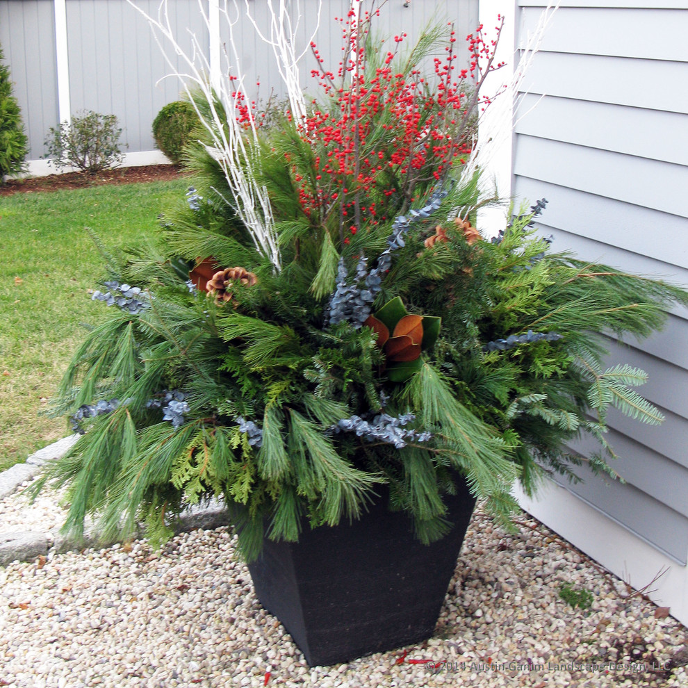 This is an example of a nautical front partial sun garden for winter in New York with a potted garden and gravel.