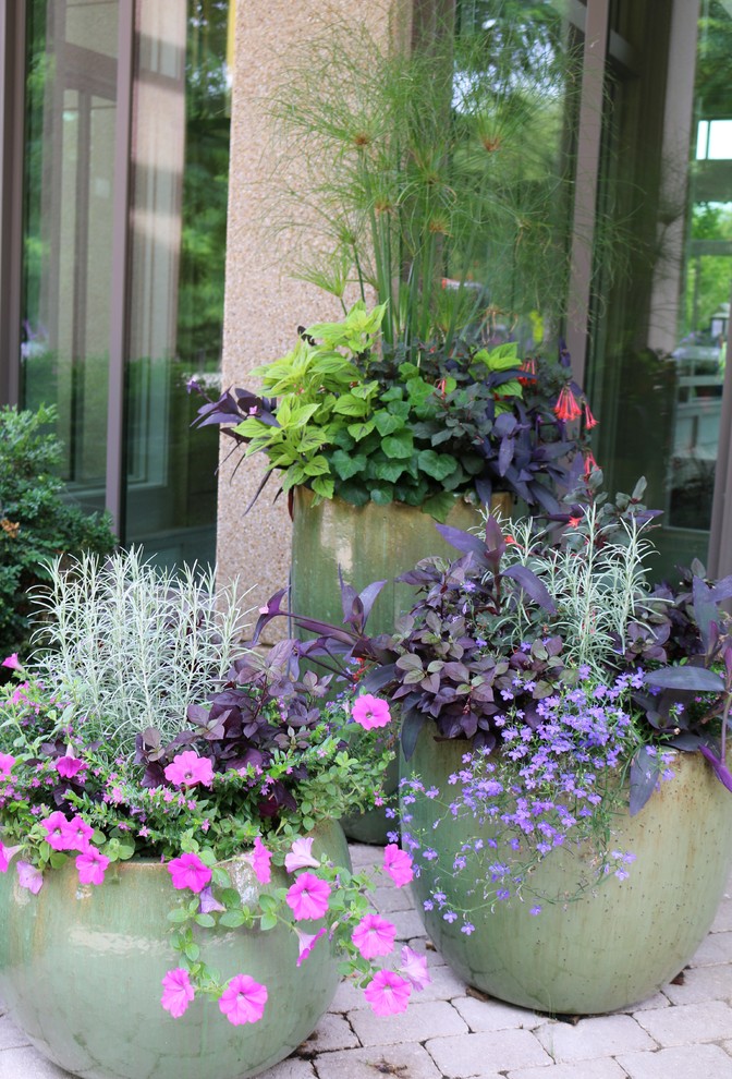This is an example of a bohemian partial sun garden for summer in Chicago with a potted garden.