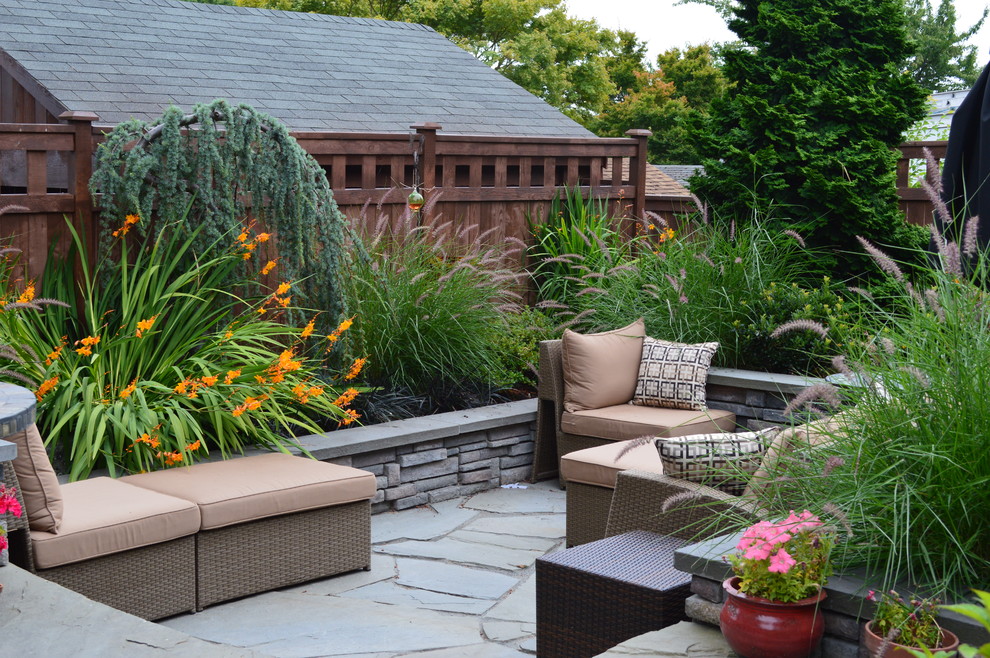 Inspiration for a small eclectic back partial sun garden for summer in Seattle with natural stone paving.