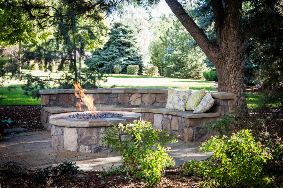 This is an example of a large mediterranean full sun backyard stone landscaping in Denver for summer.