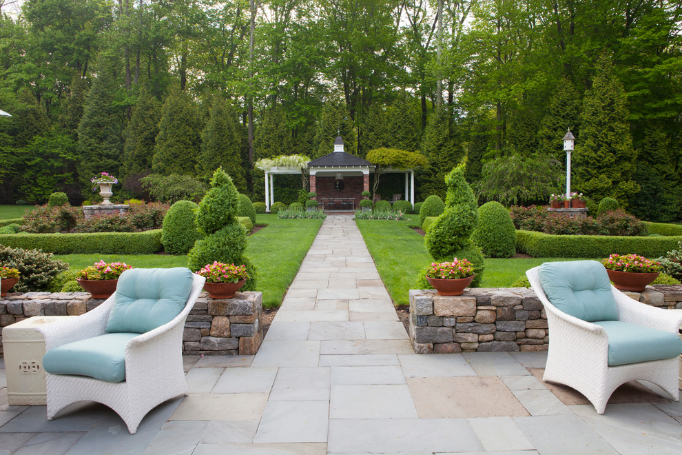 Medium sized classic back formal partial sun garden for spring in New York with a garden path and concrete paving.
