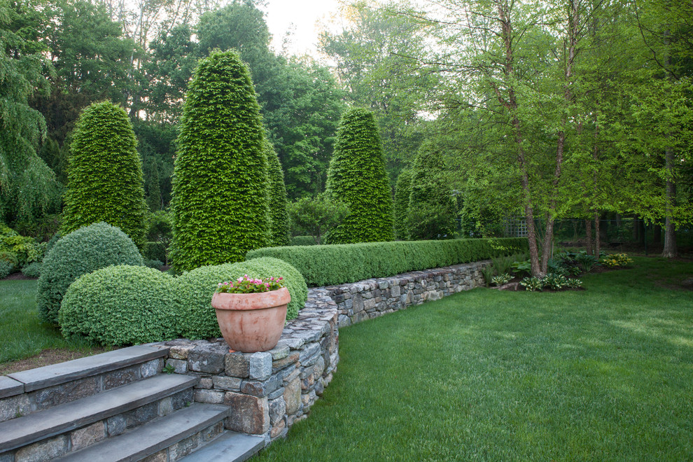 Photo of a mid-sized traditional partial sun backyard formal garden in New York.