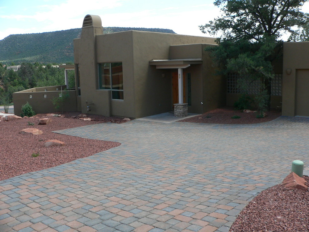 This is an example of a large southwestern full sun front yard concrete paver driveway in Phoenix.