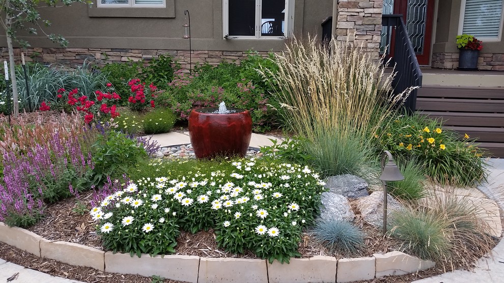 Self contained water feature as a focal point among plantings