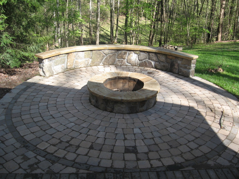 Medium sized contemporary back partial sun garden in Other with brick paving and a fire feature.
