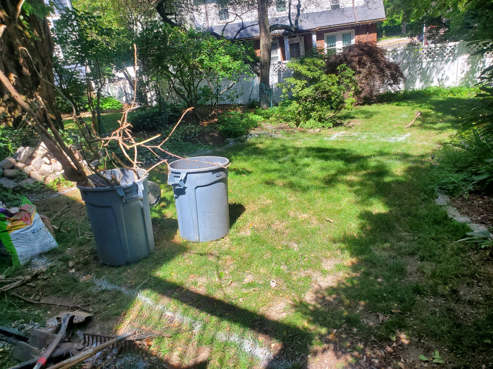На фото: маленький летний регулярный сад на заднем дворе в классическом стиле с клумбами, полуденной тенью и мощением тротуарной плиткой для на участке и в саду