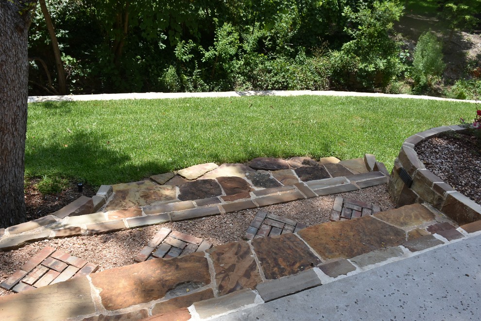 Inspiration for a mid-sized rustic hillside stone garden path in Dallas.