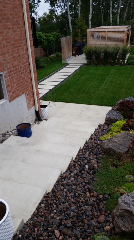 Photo of a contemporary front driveway garden in Toronto.