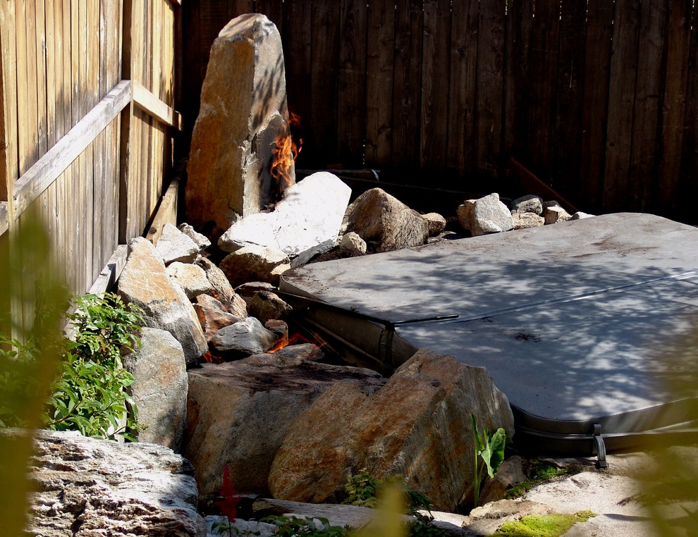 Photo of a small world-inspired back partial sun garden for winter in San Luis Obispo with a fire feature.