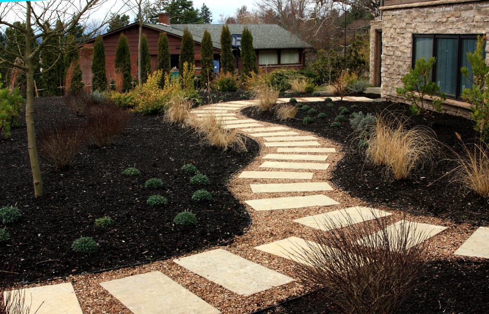 Inspiration for a mid-sized mid-century modern full sun and drought-tolerant front yard stone landscaping in Seattle.