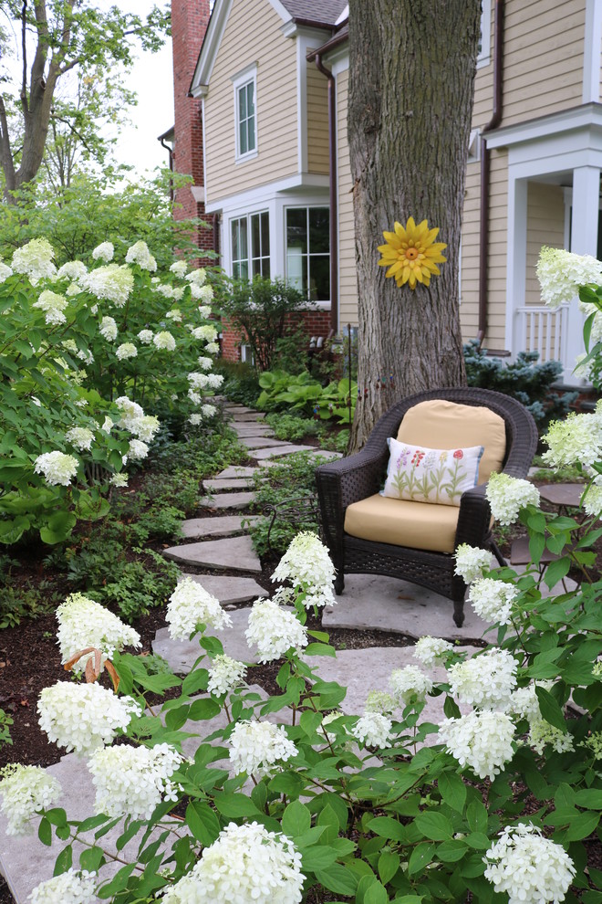 This is an example of a large farmhouse partial sun side yard stone garden path in Chicago for summer.