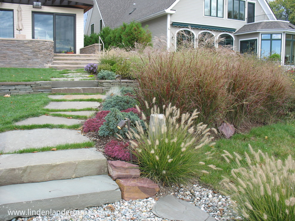 Photo of a medium sized contemporary side garden in Burlington with a garden path and natural stone paving.