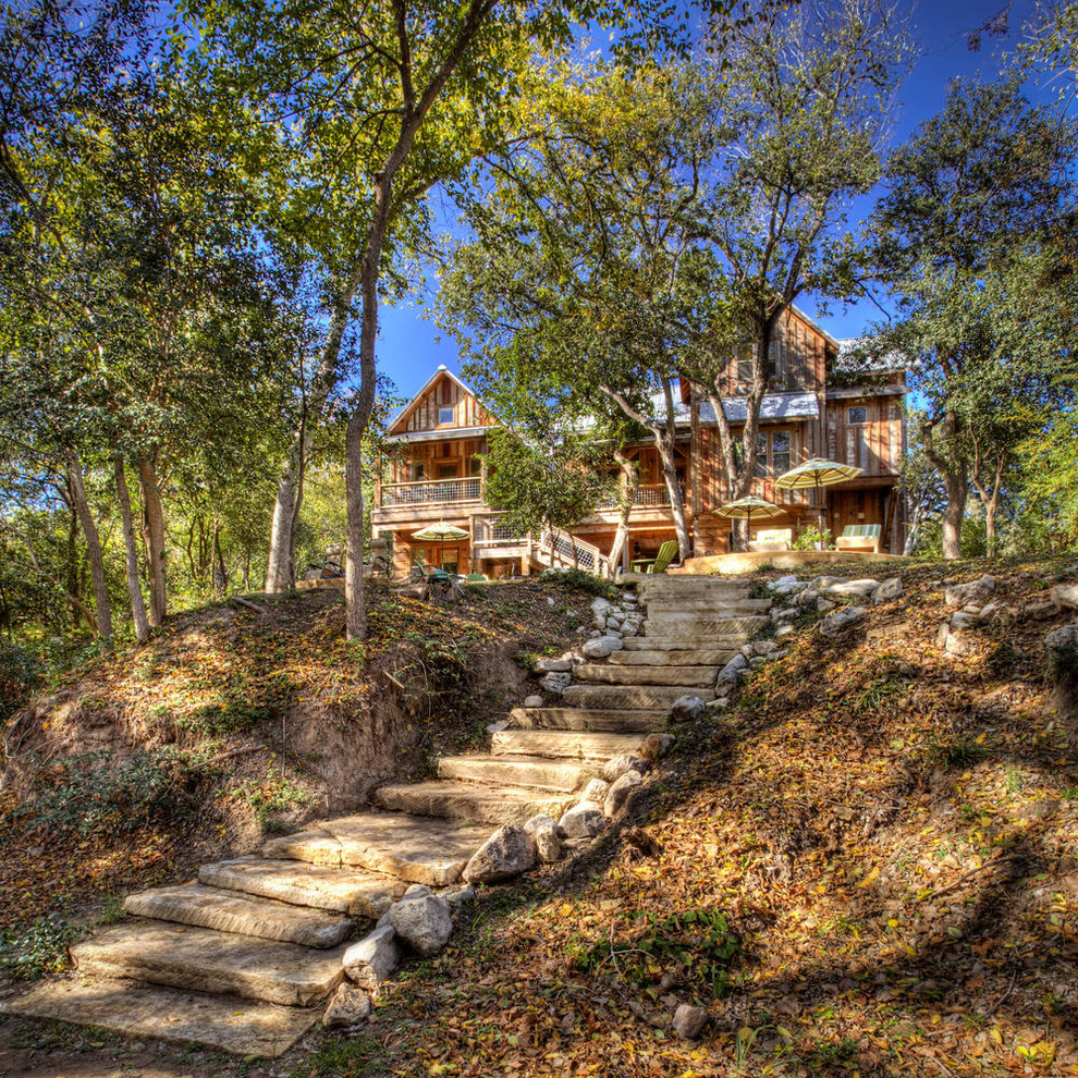 Photo of a rustic sloped fully shaded garden steps in Austin with natural stone paving.