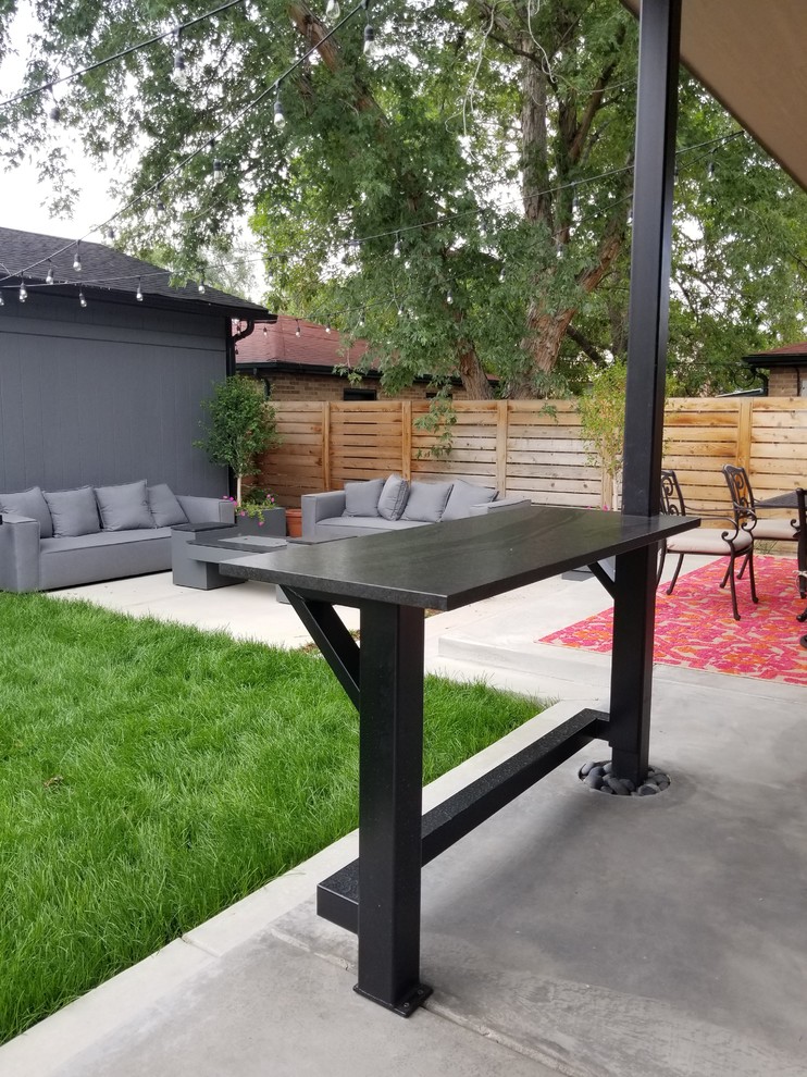 This is an example of a medium sized modern back garden in Denver.