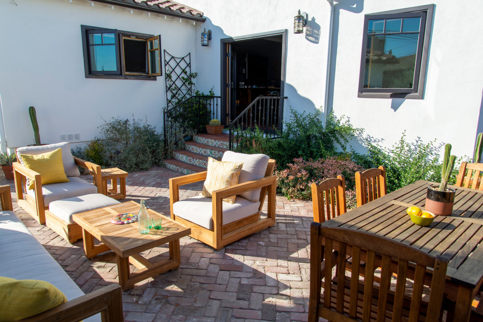 Small back xeriscape partial sun garden for summer in Los Angeles with brick paving.