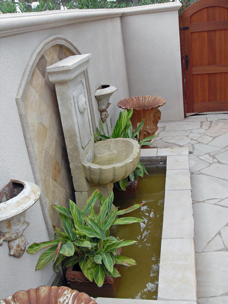 Идея дизайна: садовый фонтан среднего размера на переднем дворе в средиземноморском стиле с полуденной тенью и покрытием из каменной брусчатки