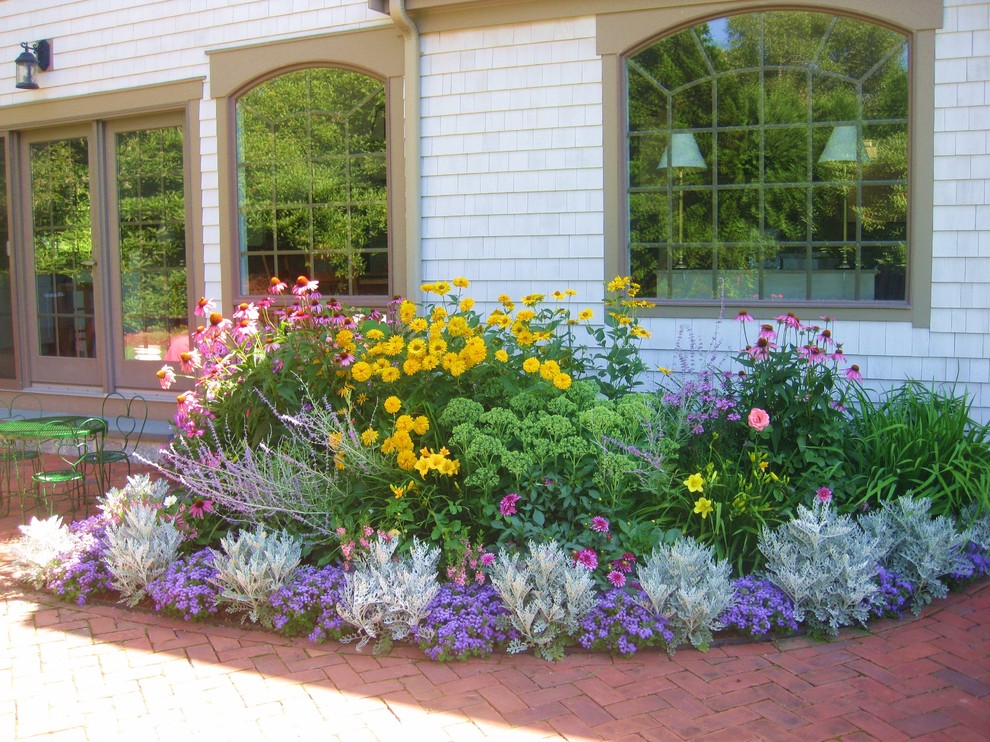 Design ideas for a large classic back partial sun garden for summer in Boston with a potted garden and brick paving.