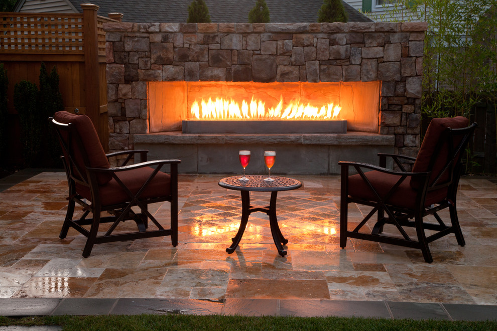 Patio - traditional backyard stone patio idea in DC Metro with a fire pit