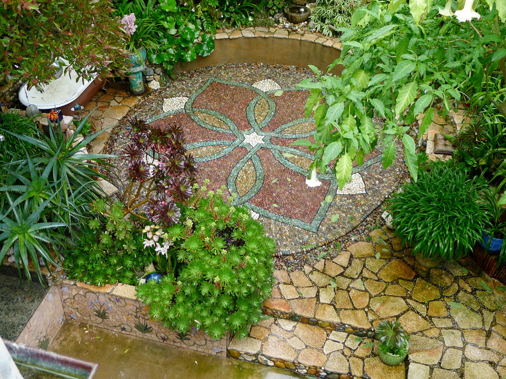 Bohemian back garden wall in San Francisco with natural stone paving.