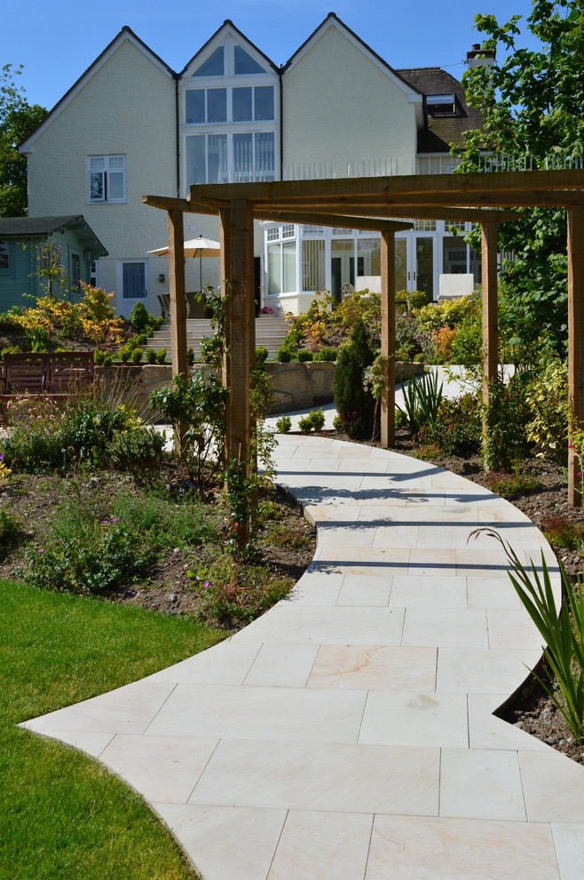 Design ideas for a classic back formal full sun garden in West Midlands with natural stone paving.