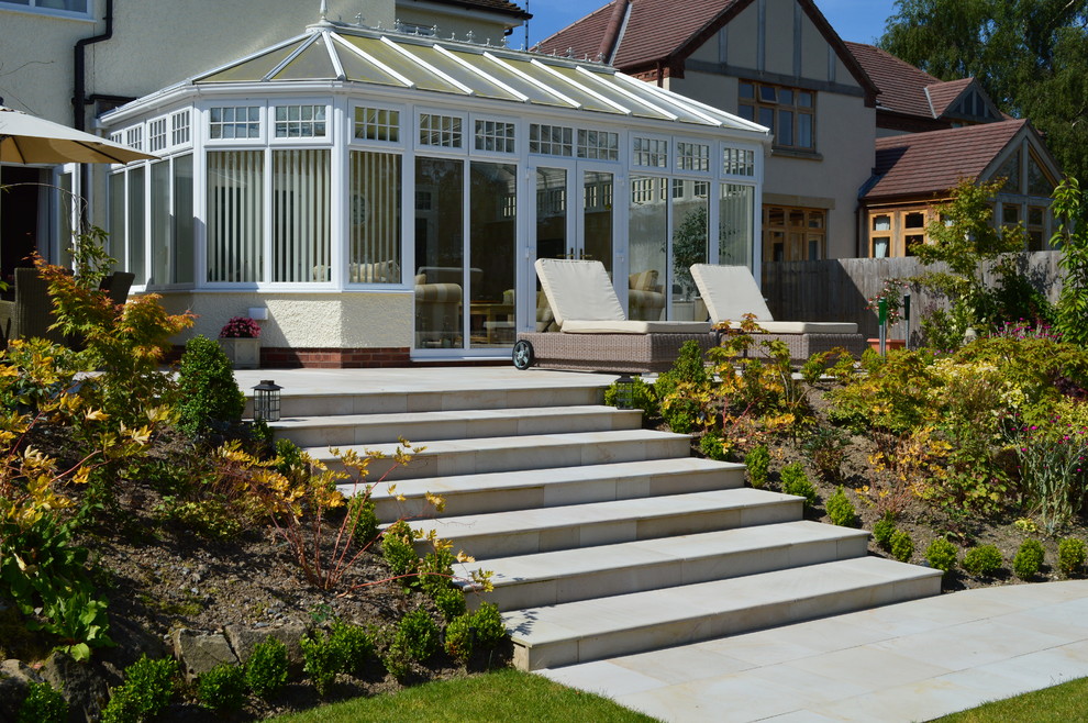 Photo of a large traditional back full sun garden in West Midlands with natural stone paving.