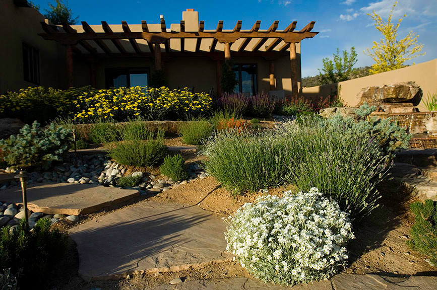 Inspiration for a large drought-tolerant and partial sun backyard stone landscaping.