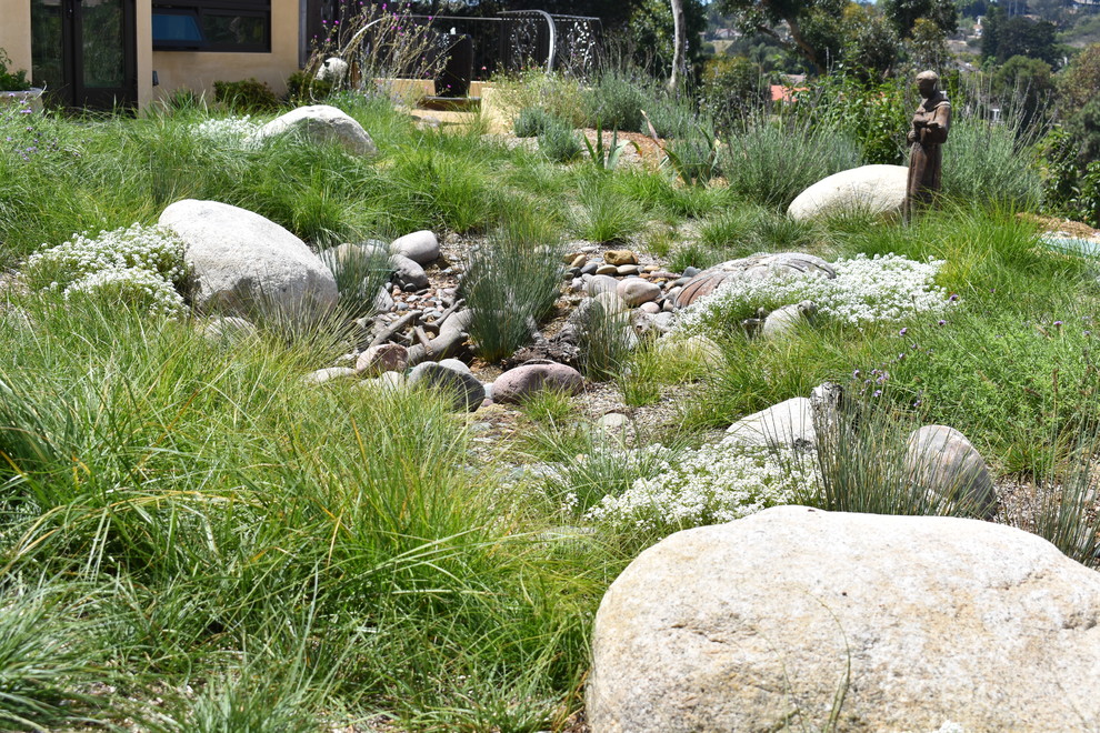 This is an example of a large rustic back xeriscape full sun garden in San Diego with a garden path and gravel.