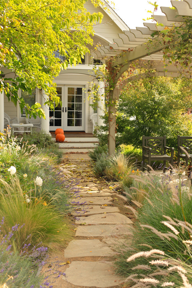 Foto di un grande giardino tradizionale esposto a mezz'ombra davanti casa in estate con un giardino in vaso e ghiaia