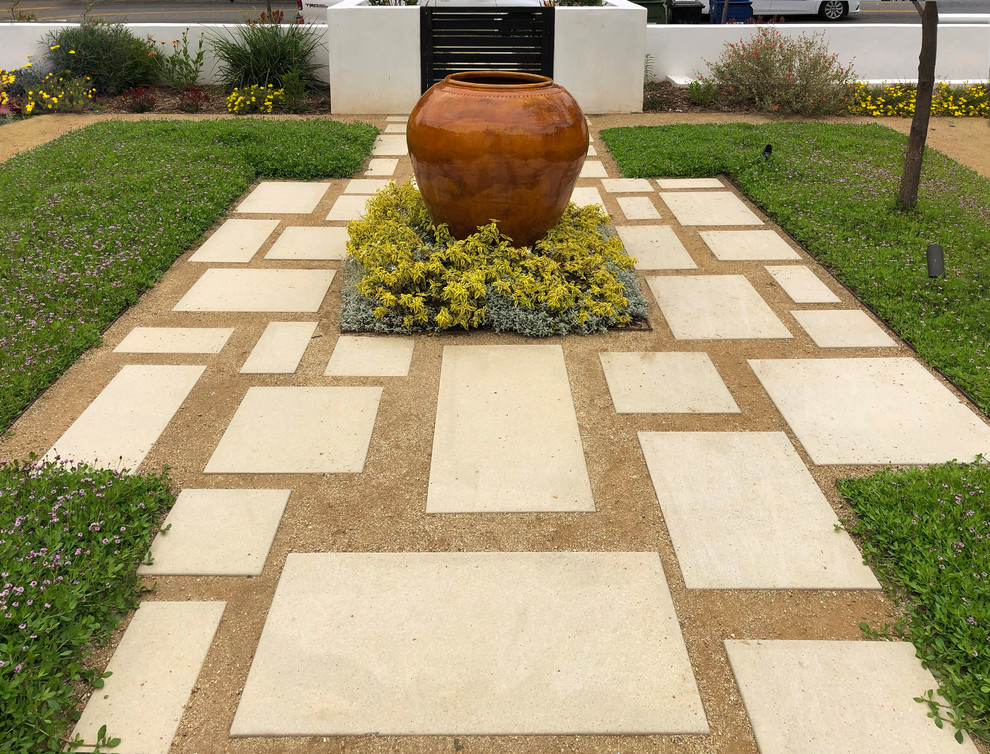 This is an example of a small contemporary full sun front yard concrete paver landscaping for spring.