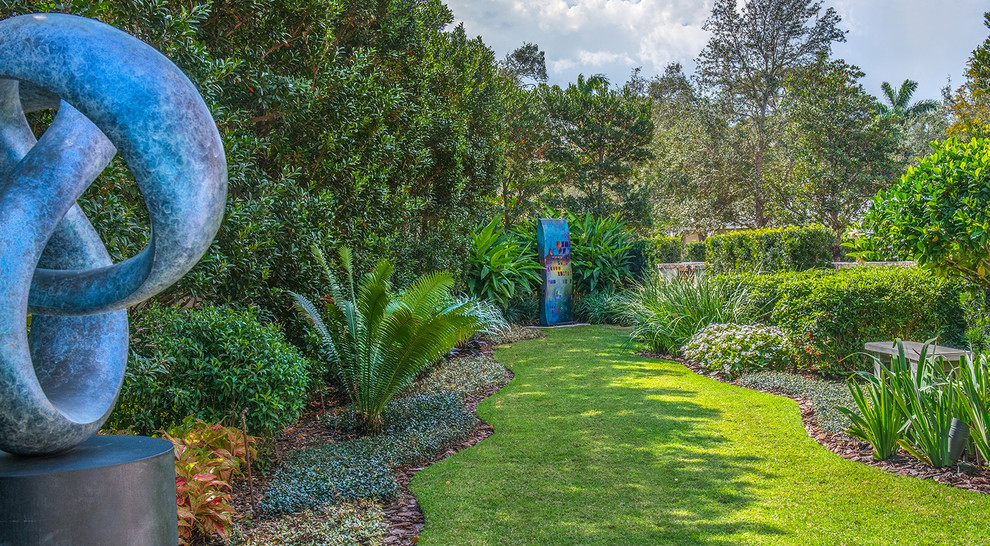 Inspiration for a large traditional partial sun backyard formal garden in Miami.