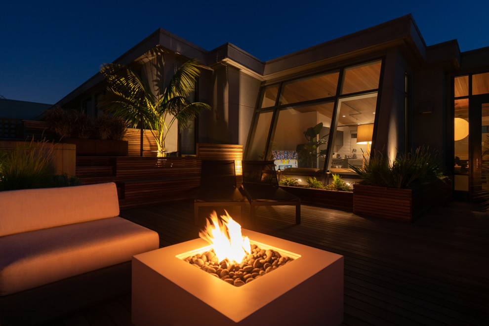Design ideas for a small modern full sun rooftop landscaping in San Francisco with a fire pit and decking.