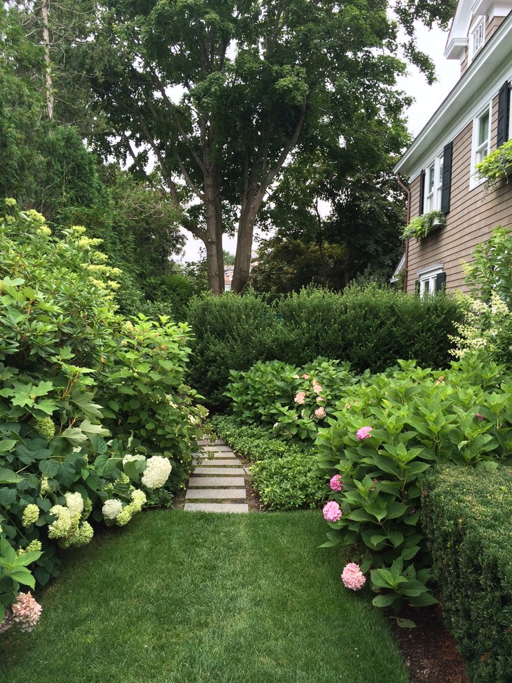 This is an example of a large traditional partial sun backyard stone garden path in New York for summer.