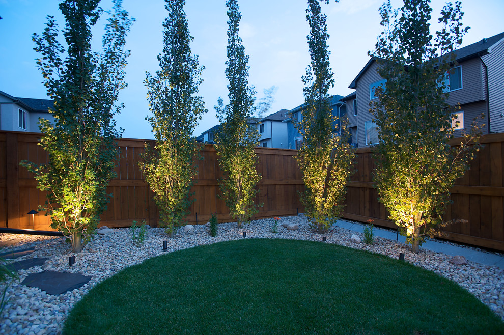 Photo of a mid-sized traditional backyard landscaping in Calgary.