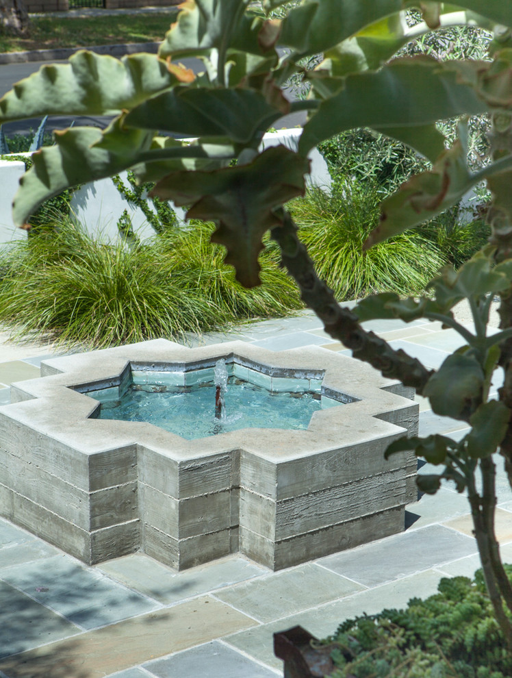 Exemple d'un petit jardin sur cour méditerranéen avec une exposition ensoleillée et des pavés en pierre naturelle.