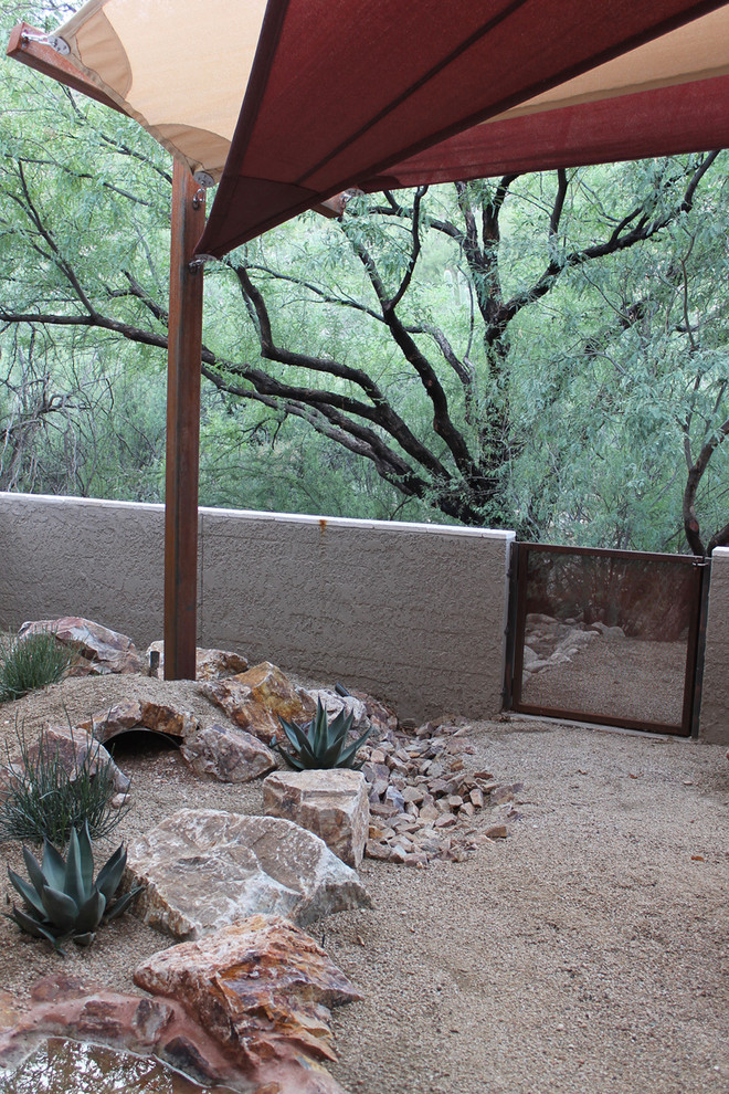 Ispirazione per un piccolo giardino xeriscape minimalista esposto in pieno sole dietro casa con pavimentazioni in pietra naturale