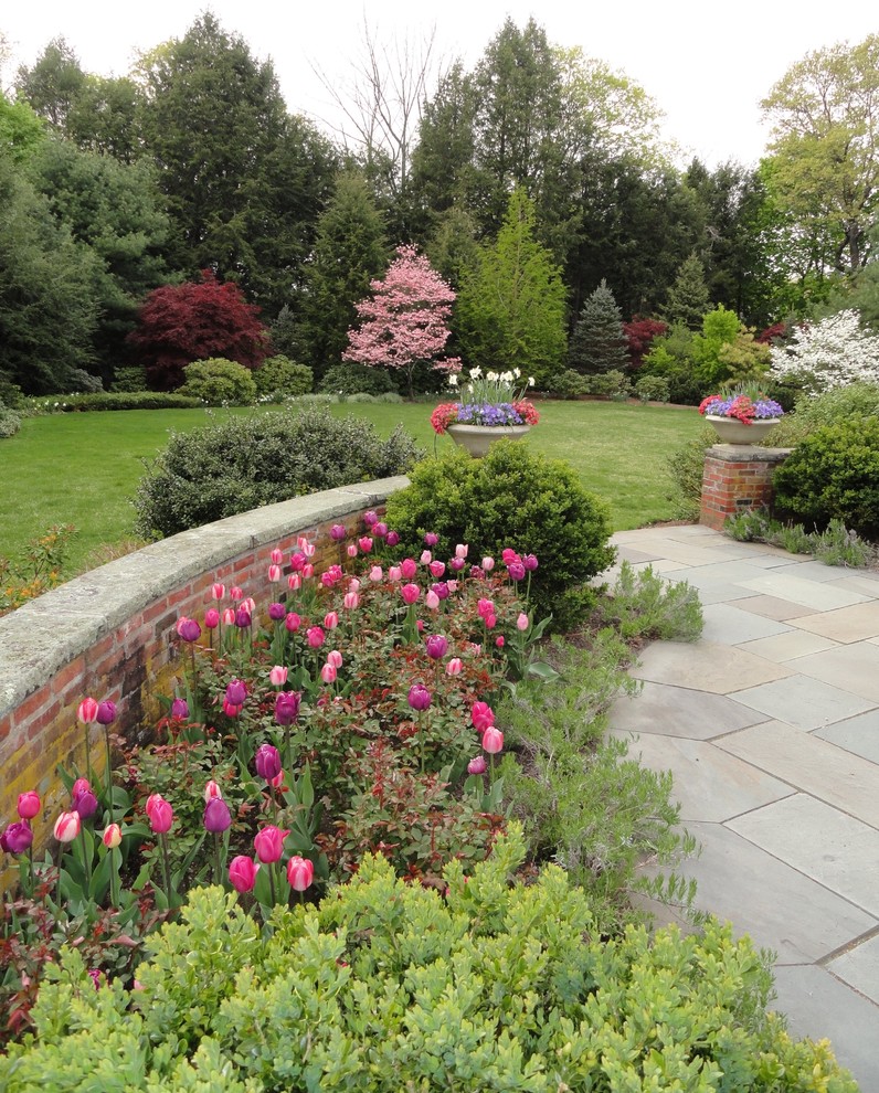 This is an example of a mid-sized traditional full sun front yard stone landscaping in Boston.