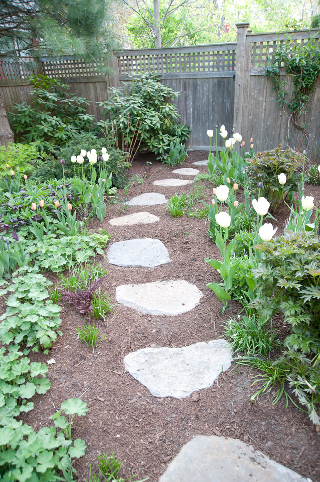 Classic garden in Boston with a garden path and natural stone paving.