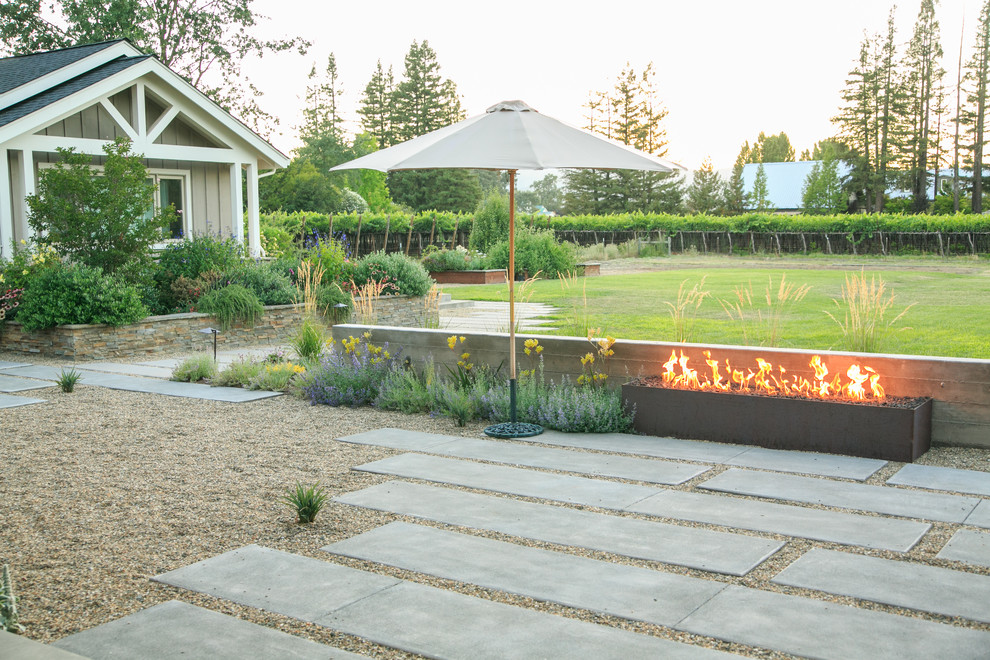 This is an example of a large contemporary backyard gravel landscaping in San Francisco with a fire pit.