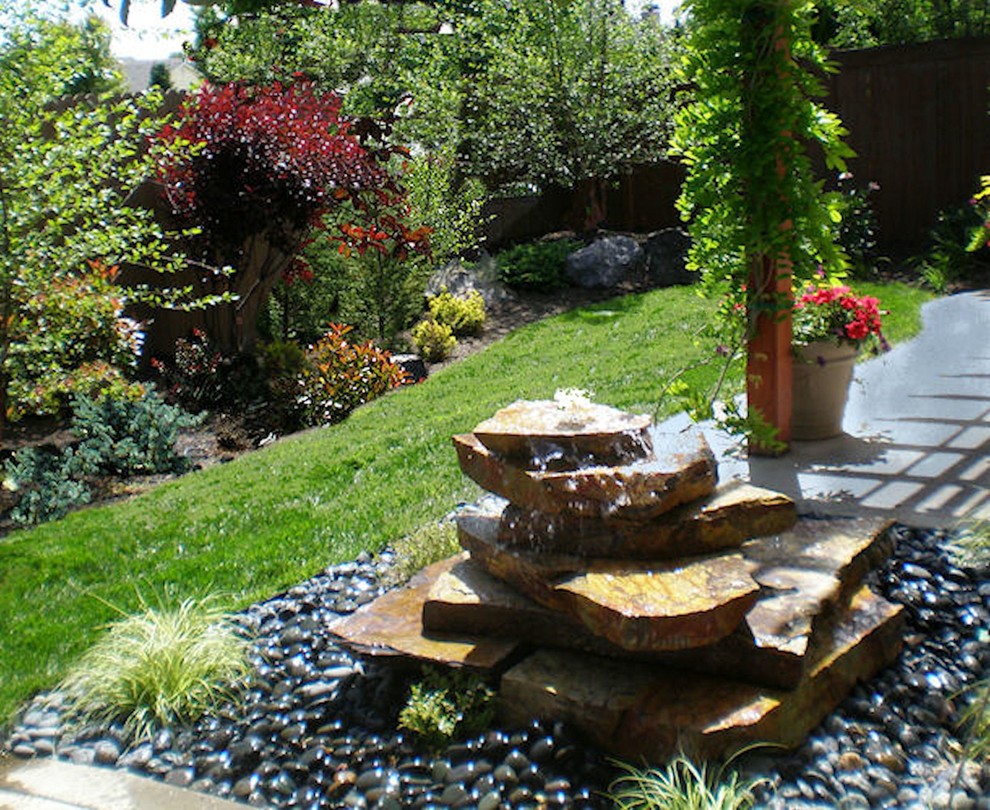 Inspiration for a mid-sized contemporary backyard water fountain landscape in Boise.