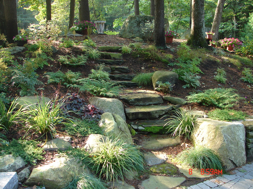 Inspiration for a rustic sloped fully shaded garden in Boston with a garden path and natural stone paving.