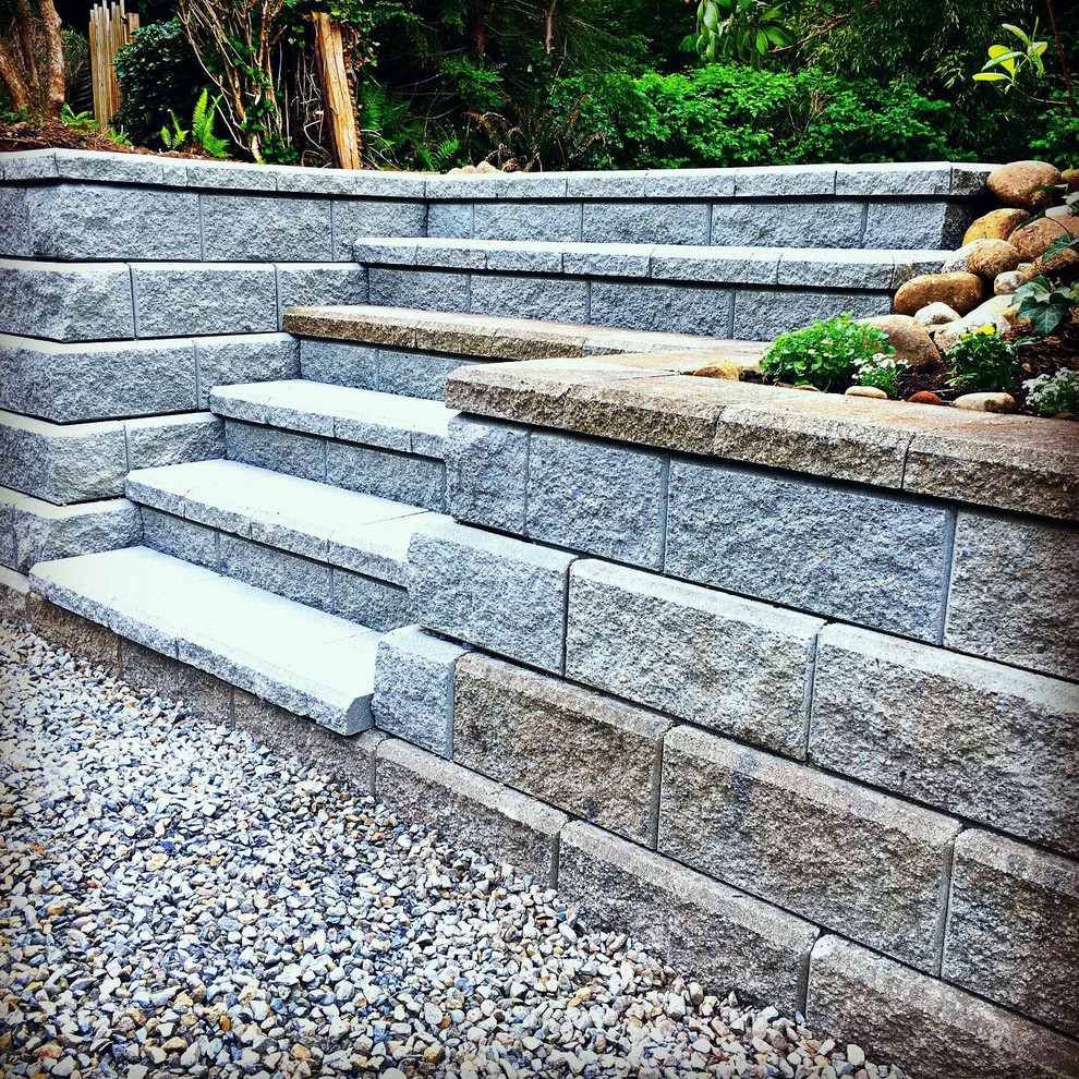 Classic back fully shaded garden in Vancouver with gravel.
