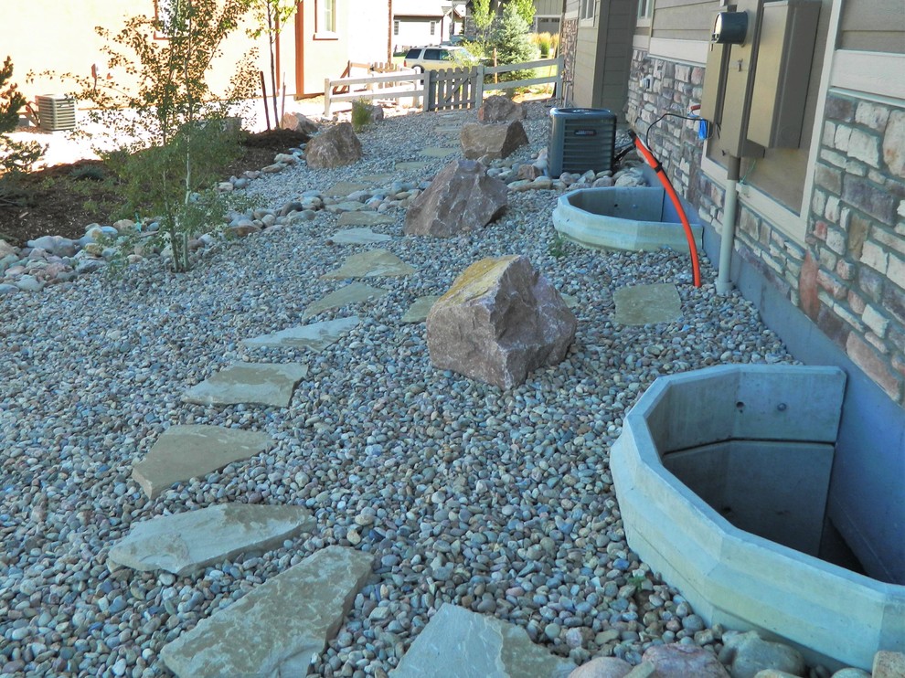 Inspiration for a medium sized contemporary side garden in Denver with a pathway and natural stone paving.