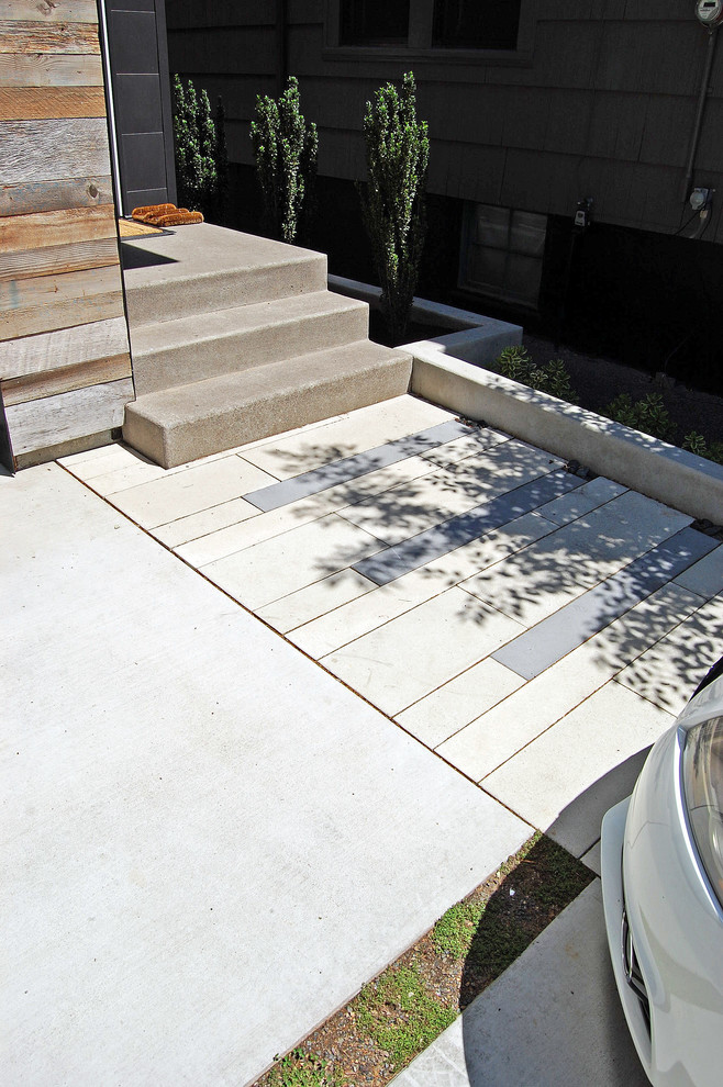 Inspiration for a small contemporary front driveway full sun garden for summer in Portland with concrete paving.