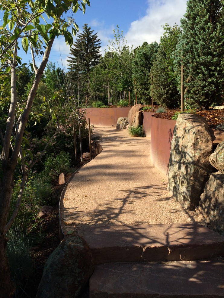 Inspiration for a large rustic side formal partial sun garden in Denver with a garden path and gravel.