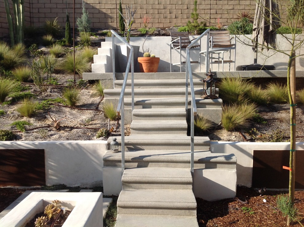 Design ideas for a large modern drought-tolerant and partial sun backyard concrete paver landscaping in San Diego for summer.