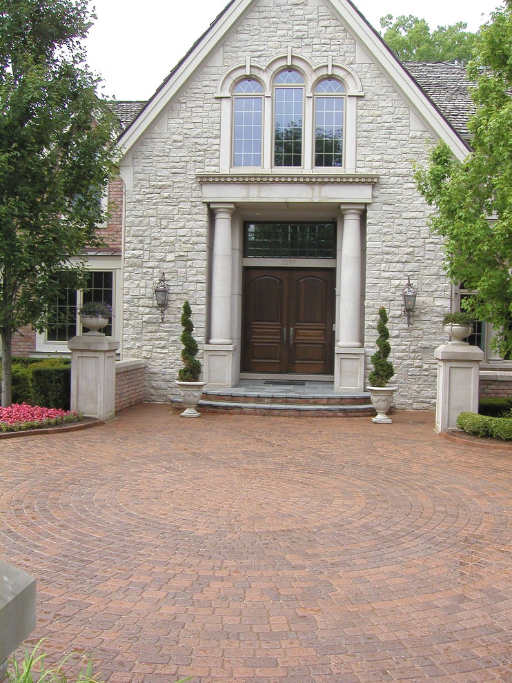 This is an example of a large front yard brick driveway in Detroit.