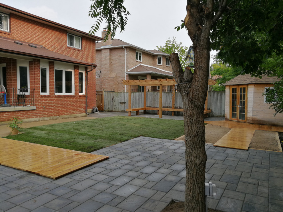 Inspiration for a mid-sized asian drought-tolerant and full sun backyard concrete paver outdoor playset in Toronto.